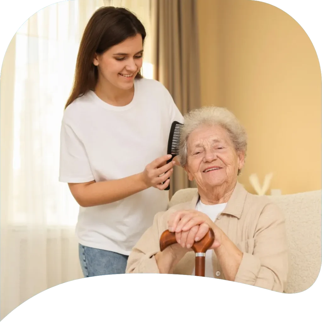 Caregiver providing personal care assistance to an elderly woman at home in Ackerman, MS